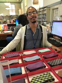  Omelio displays just some of the ties available for checkout at at the Tiebrary at Paschalville Library.